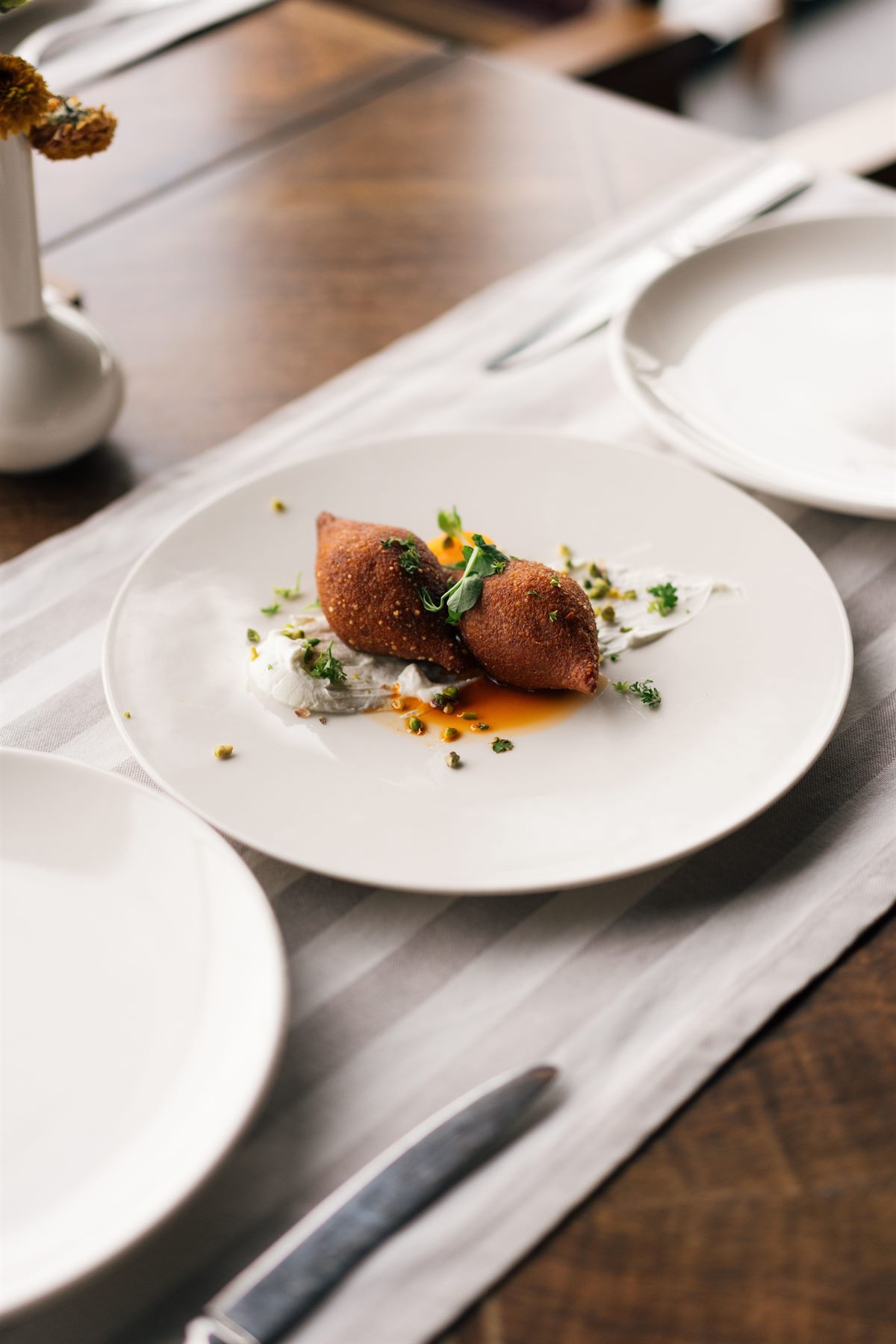 Plated starter on a laid restaurant table